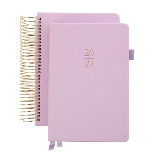 Two pink planners with gold spiral binding on a white background