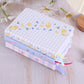 Stack of colorful fabric swatches with floral patterns on a wooden surface.