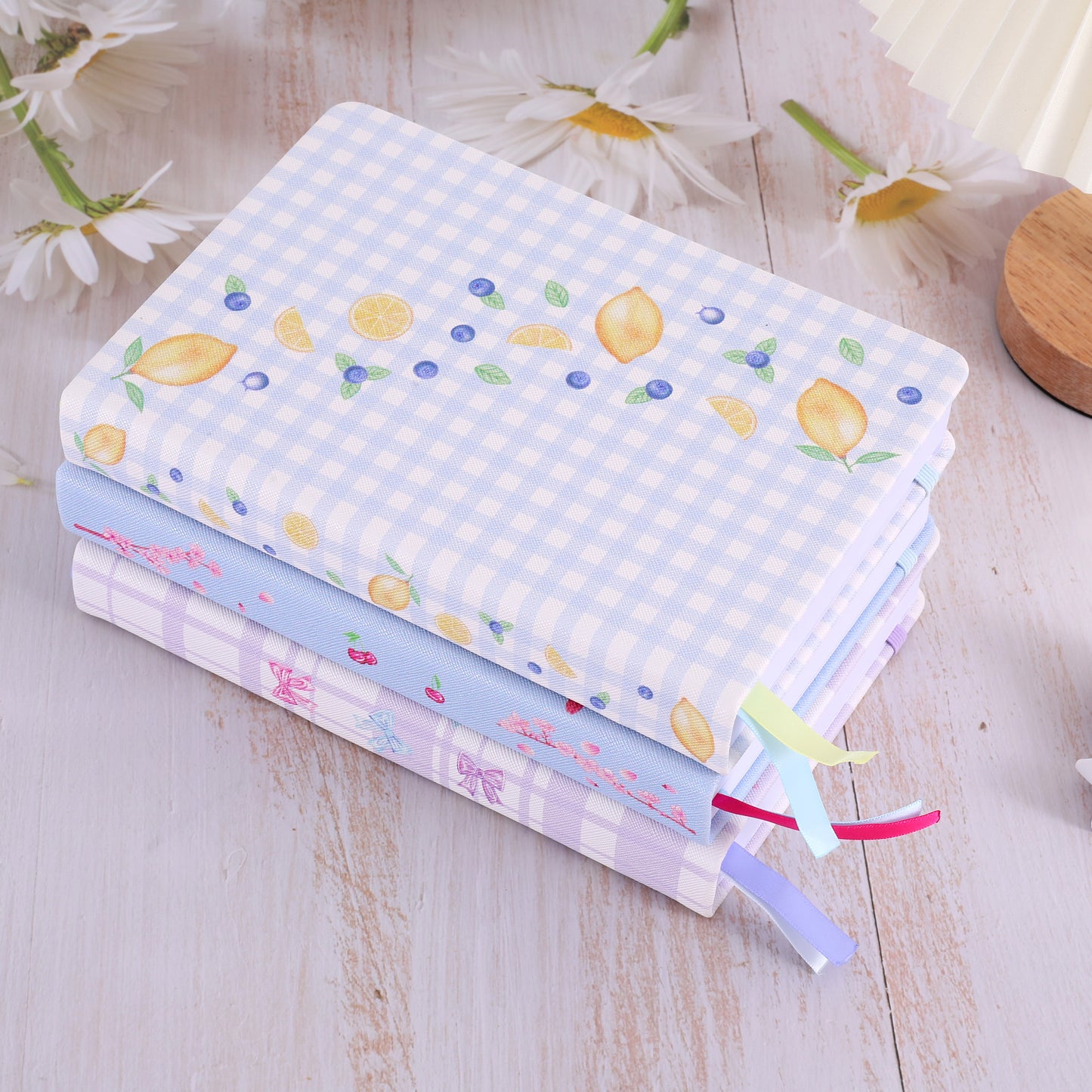 Stack of colorful fabric swatches with floral patterns on a wooden surface.