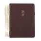 Brown planner with gold spiral binding and year embossed on the cover.
