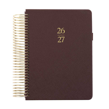Brown planner with gold spiral binding and year embossed on the cover.