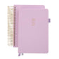 Two pink planners with gold spiral binding on a white background
