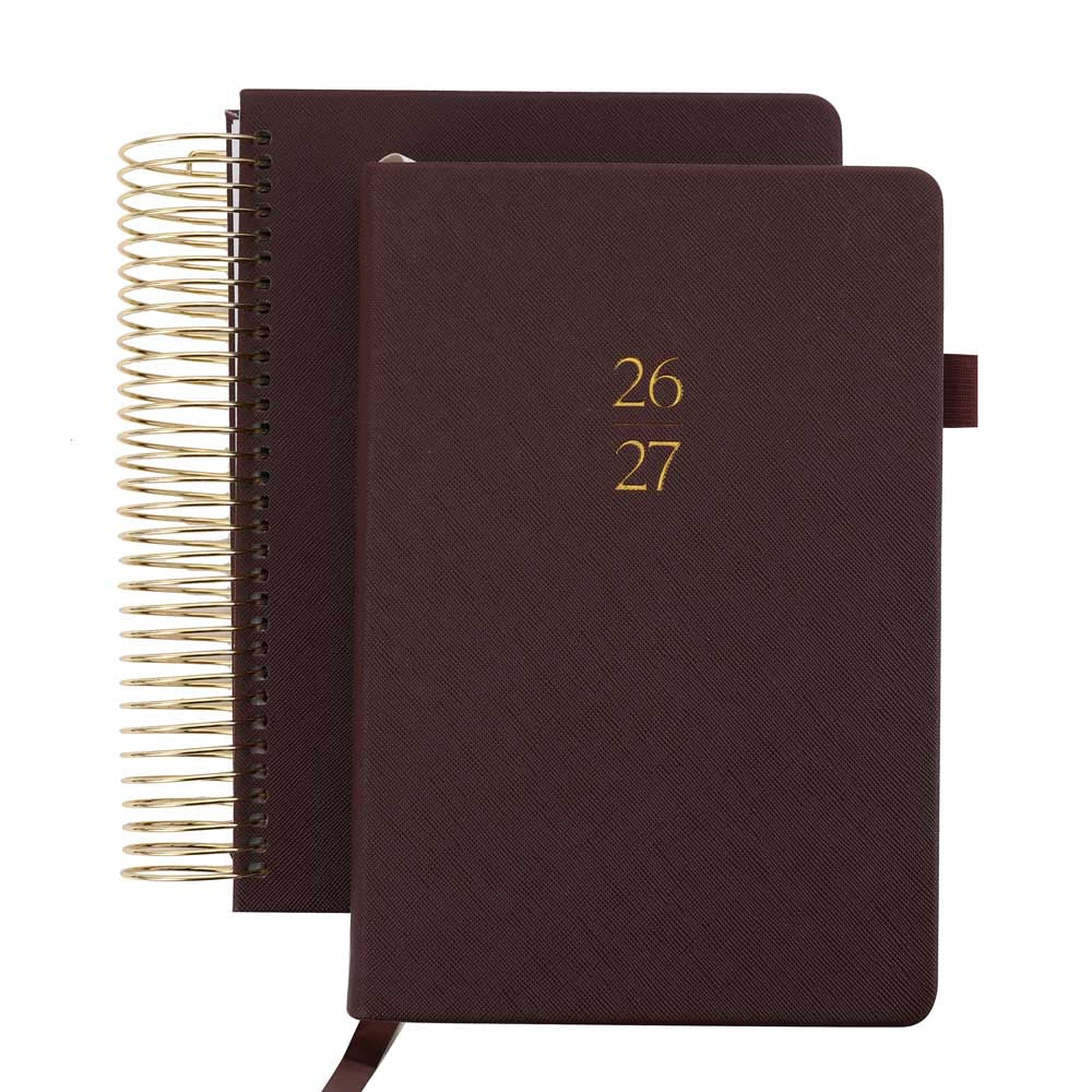 Two brown planners with gold spiral binding and embossed numbers on a white background