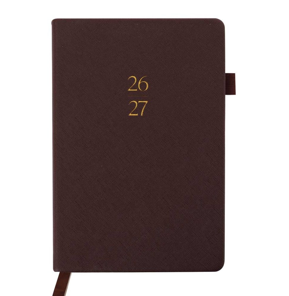 Brown planner with year embossed on the cover against a white background