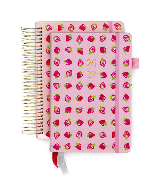 Pink planner with strawberry pattern on a white background